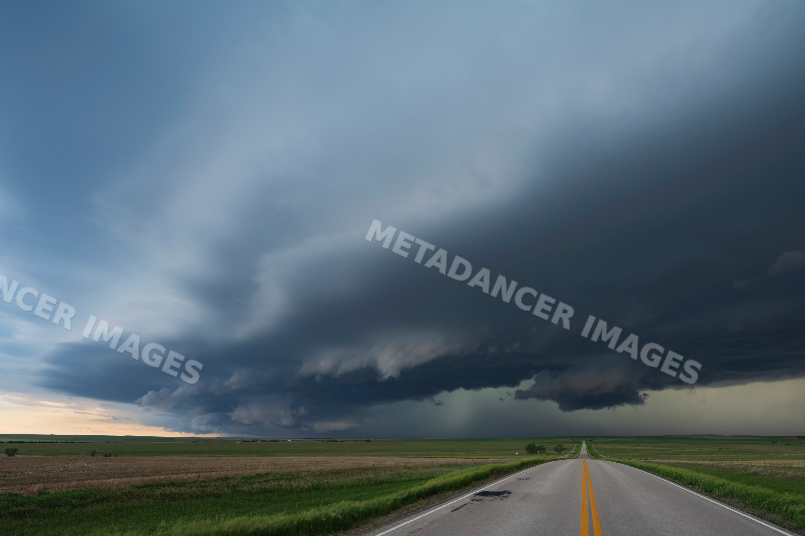 High Base Storm over open fields near wood, south dakota