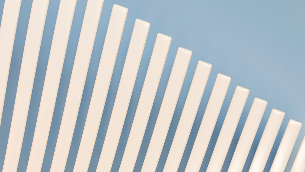Abstract arrangement of vertical cream rods on blue background