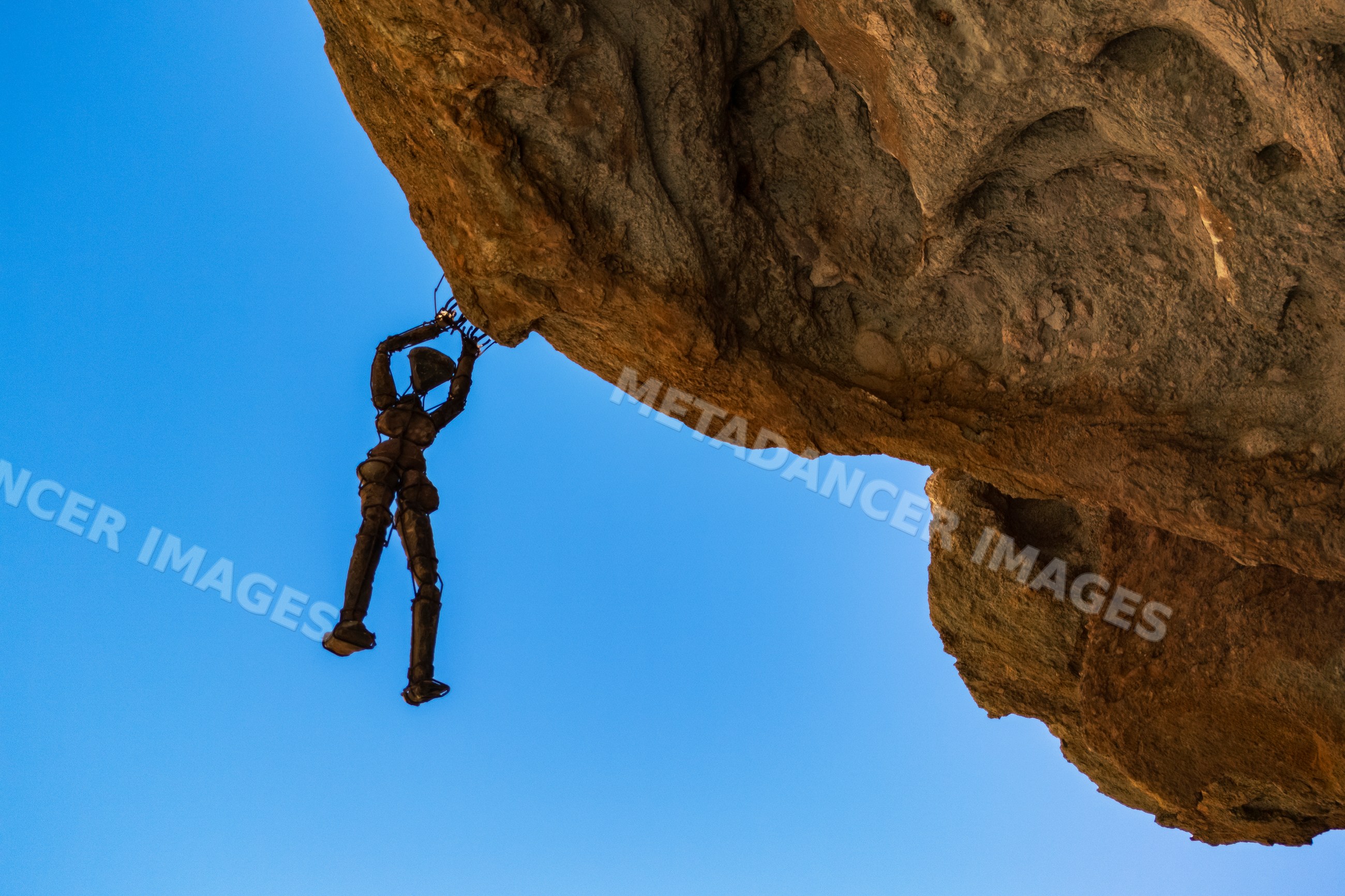 Metal sculpture hanging from cliff in sesfontein Namibia