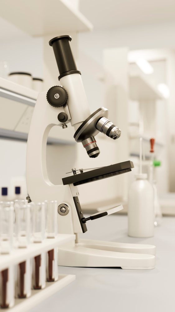 Microscope with test tubes in laboratory research setting