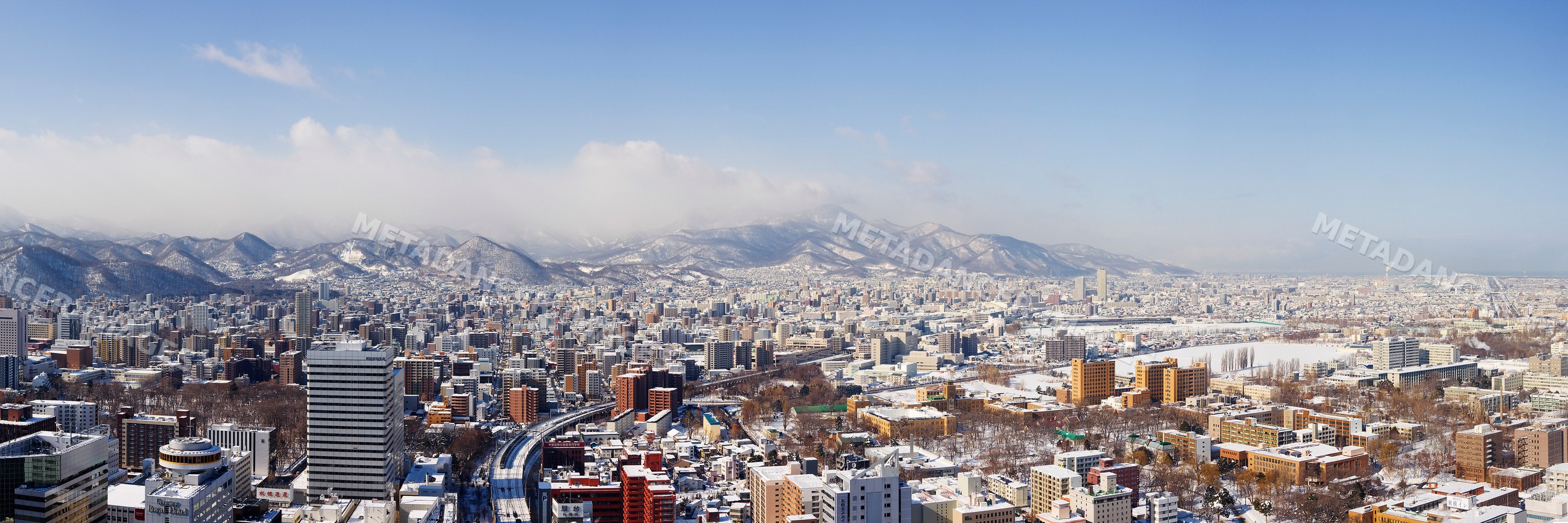 Snow-covered city skyline and mountains in sapporo hokkaido japan