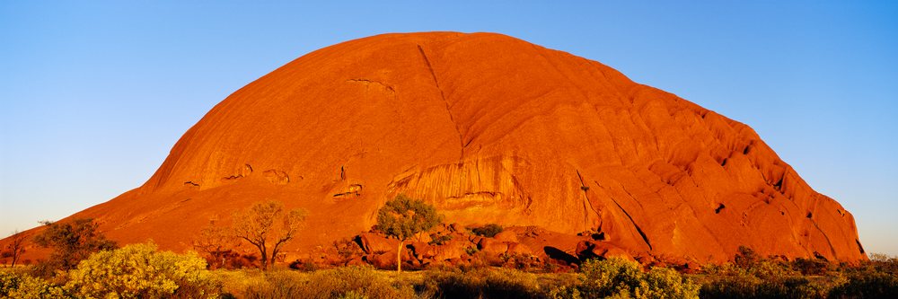 Ayers rock illuminated by sunset in northern territory australia