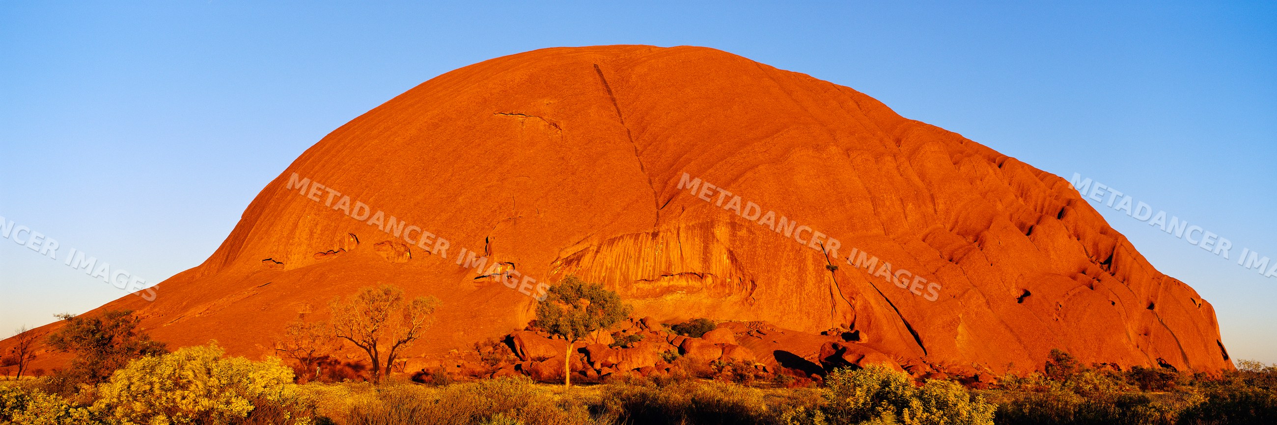 Ayers rock illuminated by sunset in northern territory australia