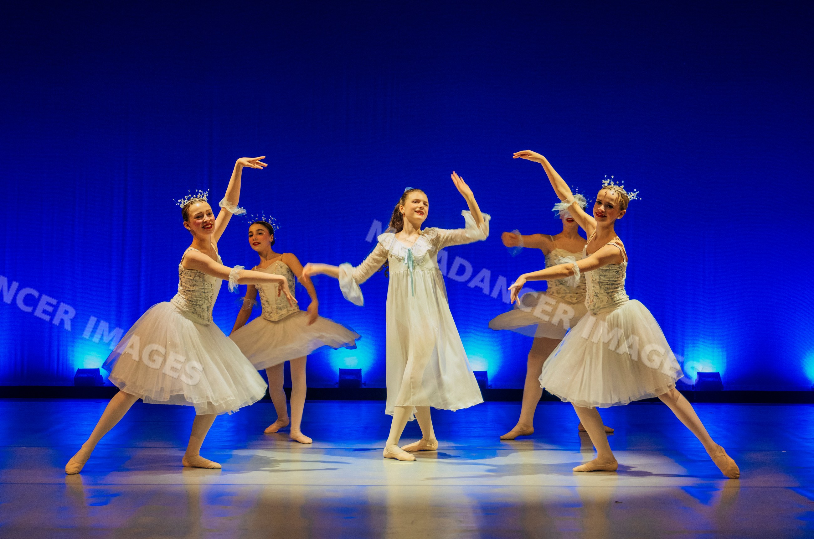 Young ballet dancers perform a classical ballet scene on stage