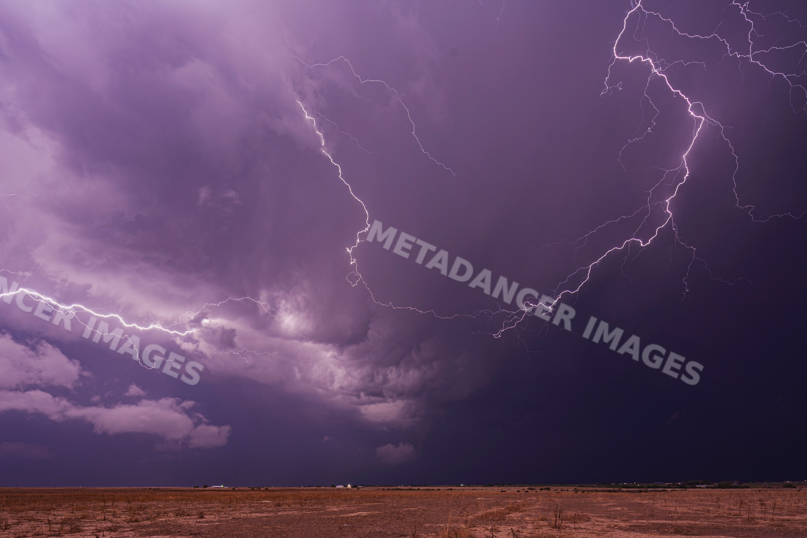 Lightning illuminates thunderstorm over dry open land in colorado, USA