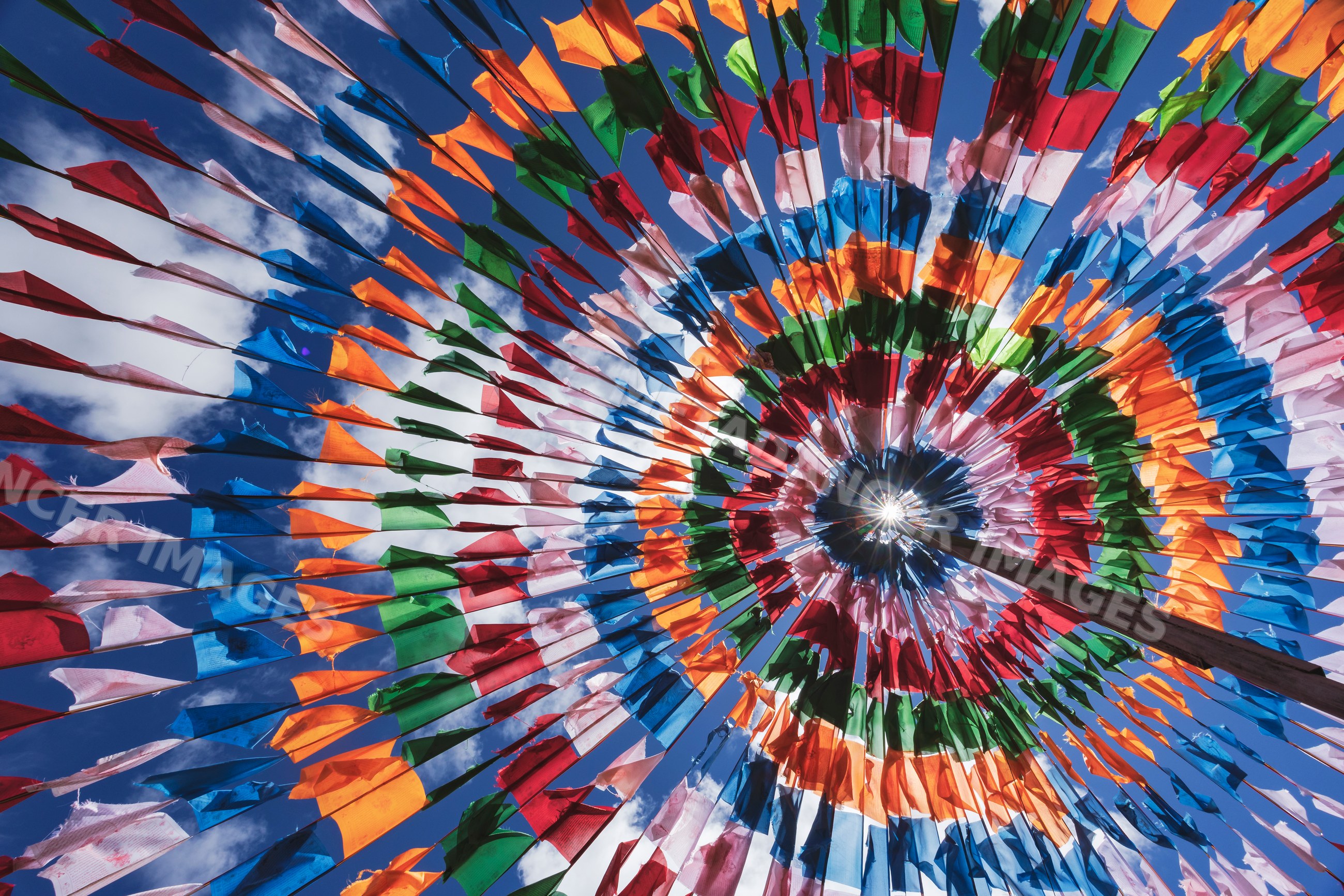 Colorful prayer flag circle in tented structure in shiqu