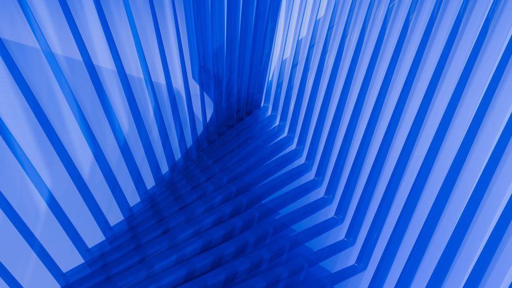 Abstract blue geometric pattern with angled lines and shadows