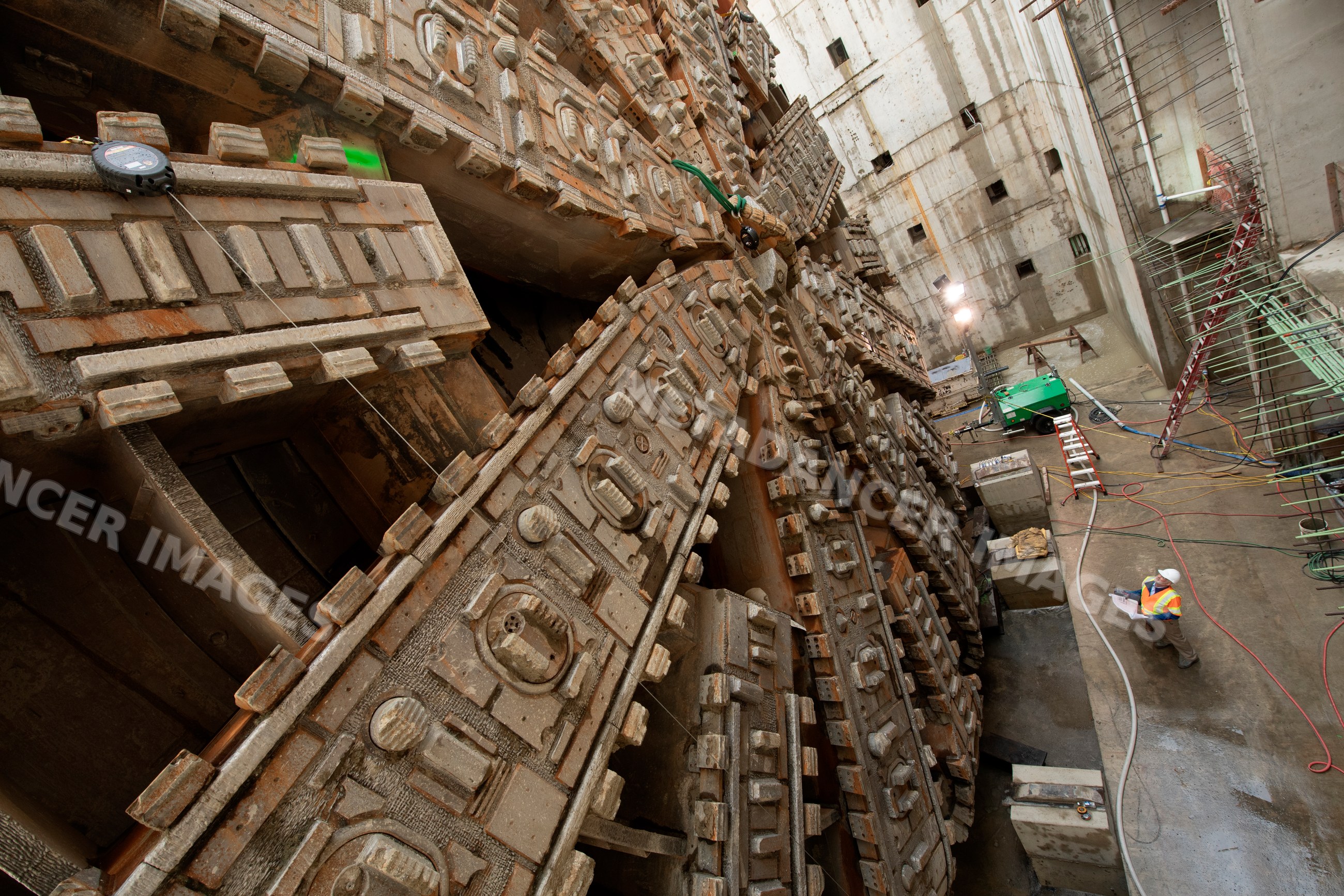 Construction white workers inspect a tunnel boring machine
