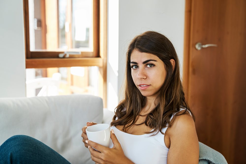 Young white woman holding a mug