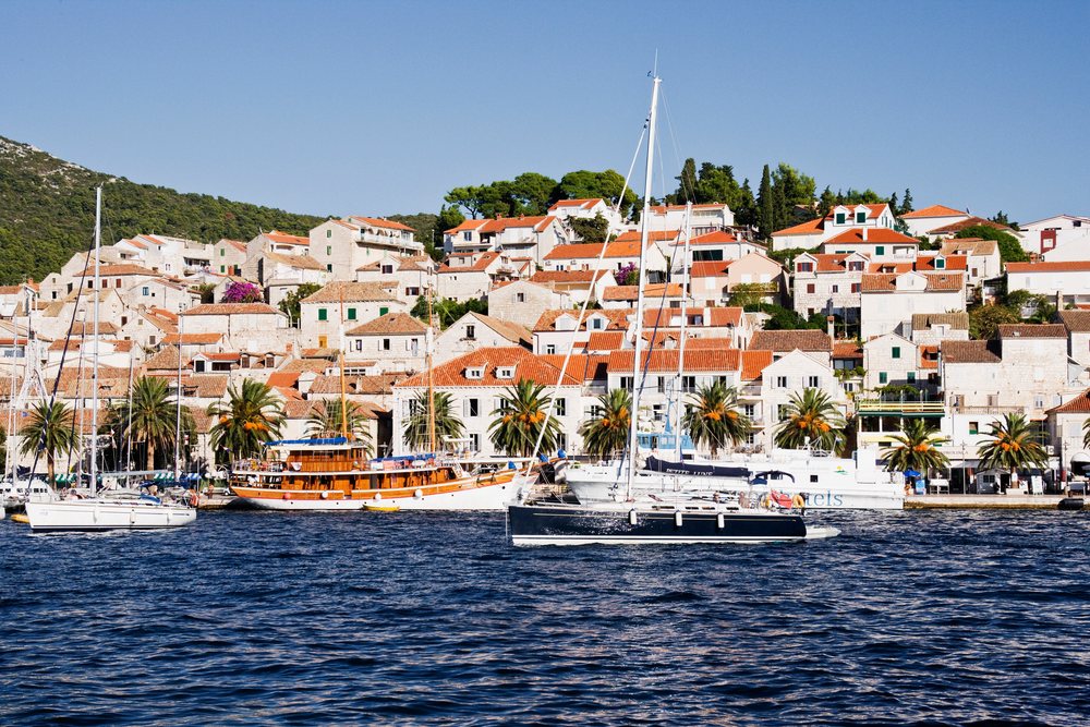Boats moored in the harbour of hvar town with coastal mediterranean