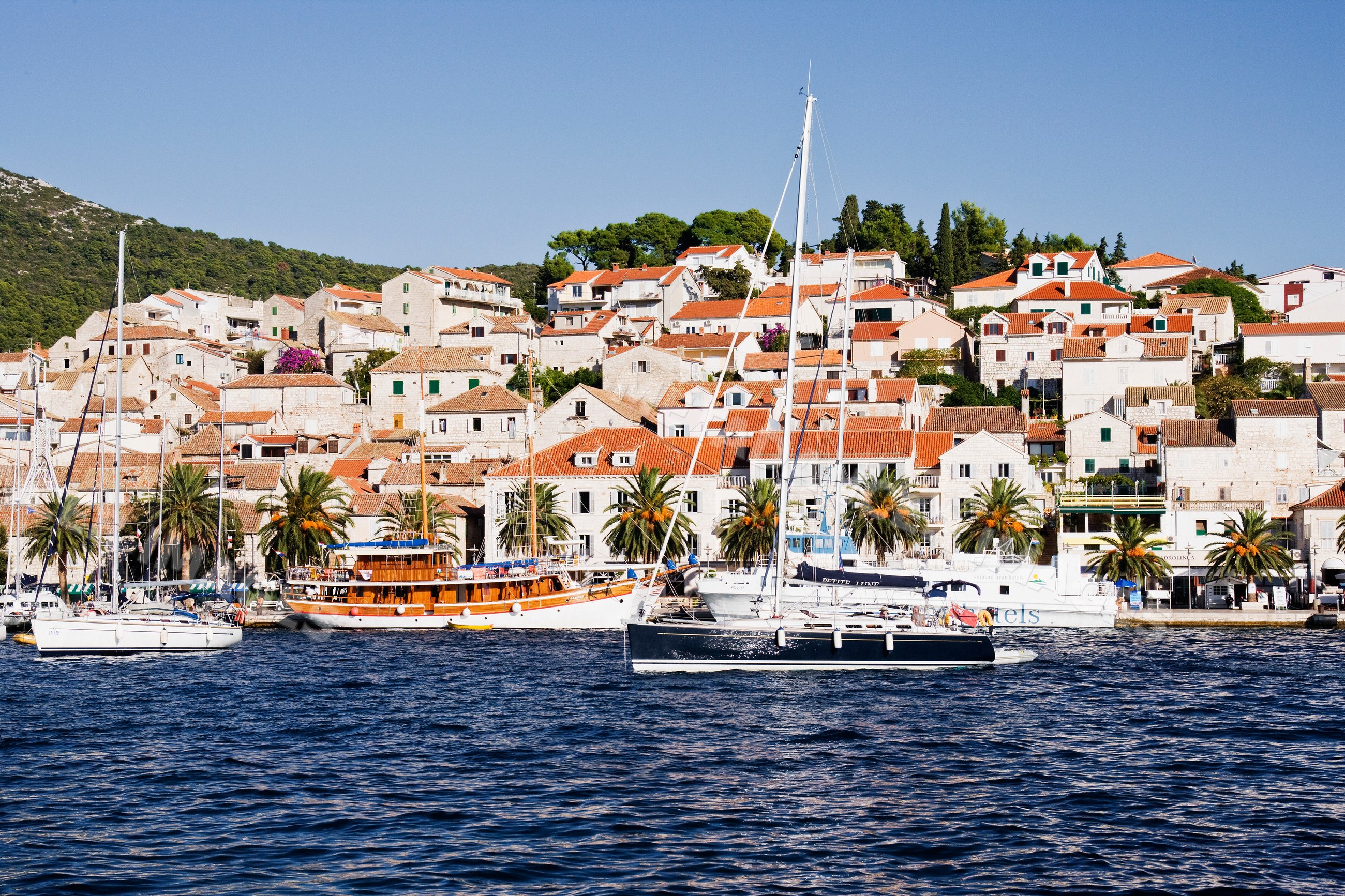 Boats moored in the harbour of hvar town with coastal mediterranean