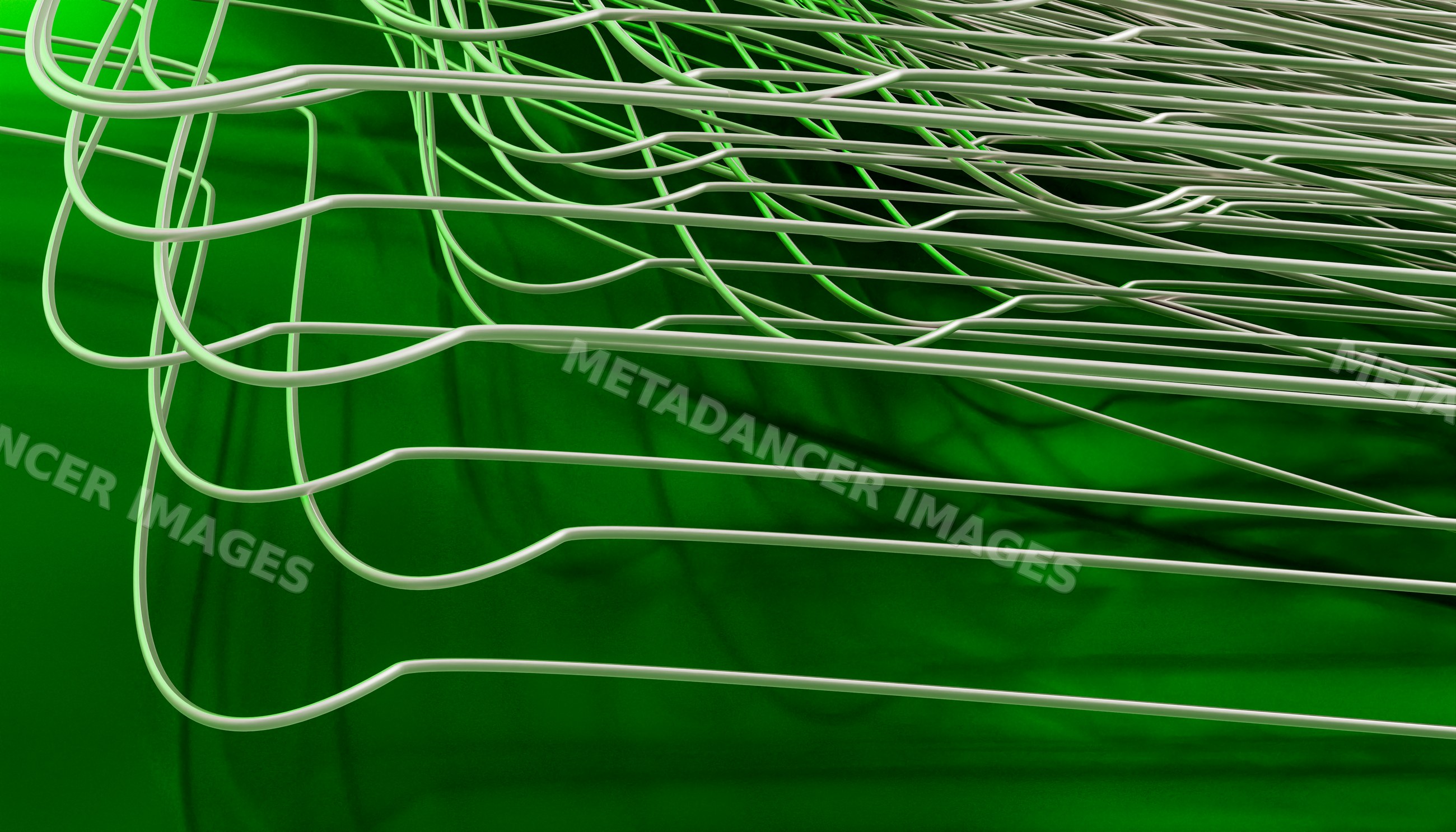 White curved wires overlapping on a green surface