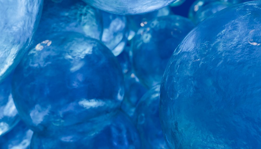 Close-up digital rendering of clustered shiny blue spheres