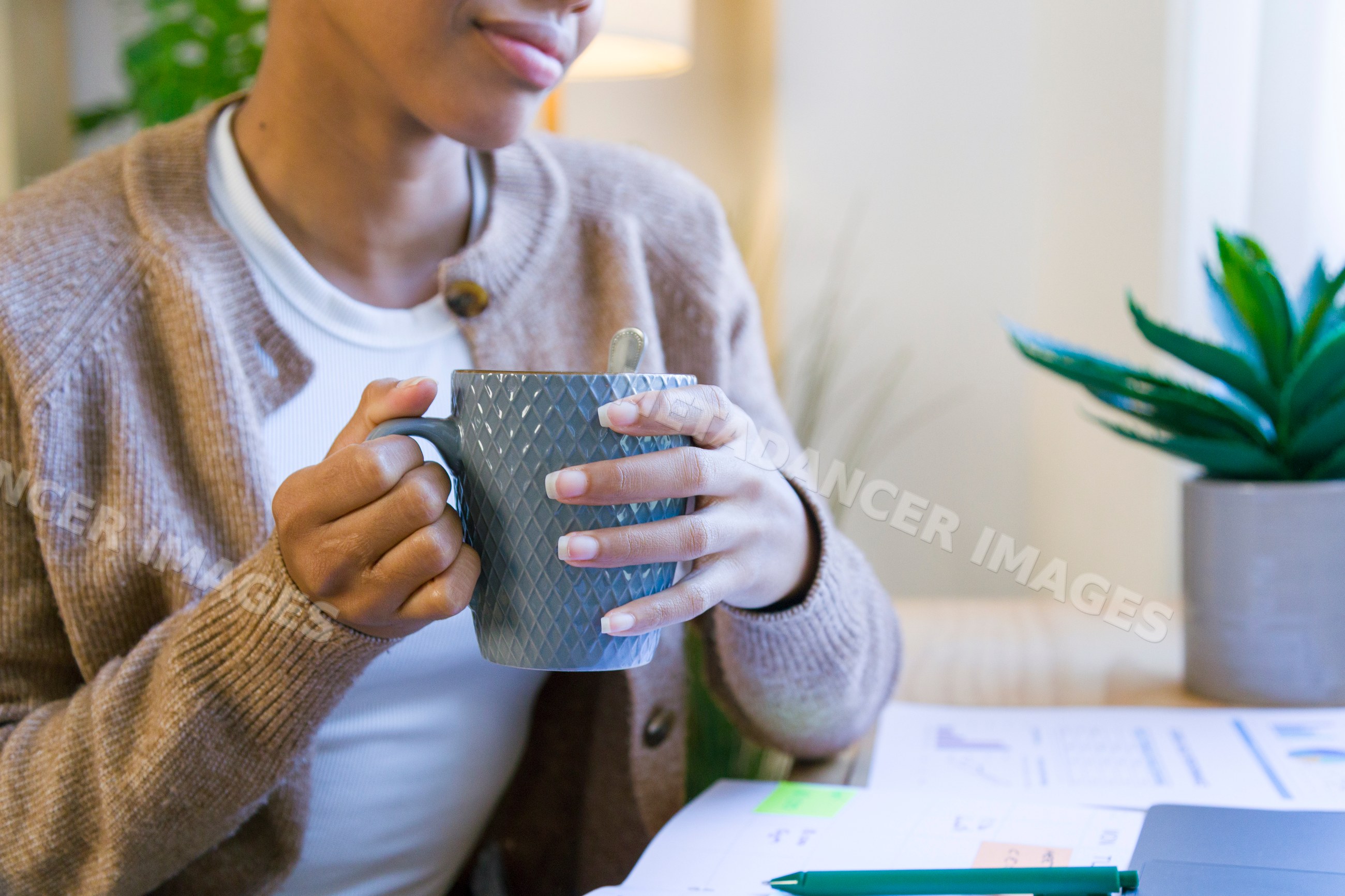 African American woman holding gray cup