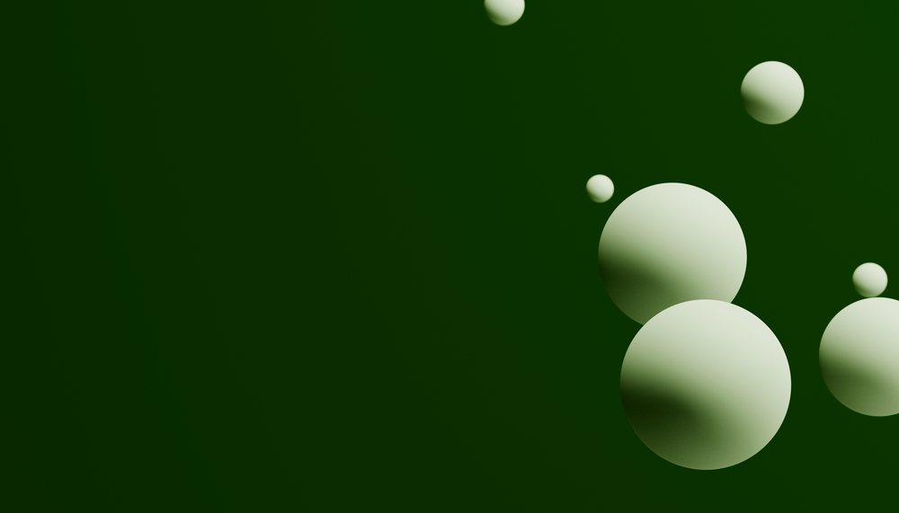 Floating white spheres with shadows on a green background