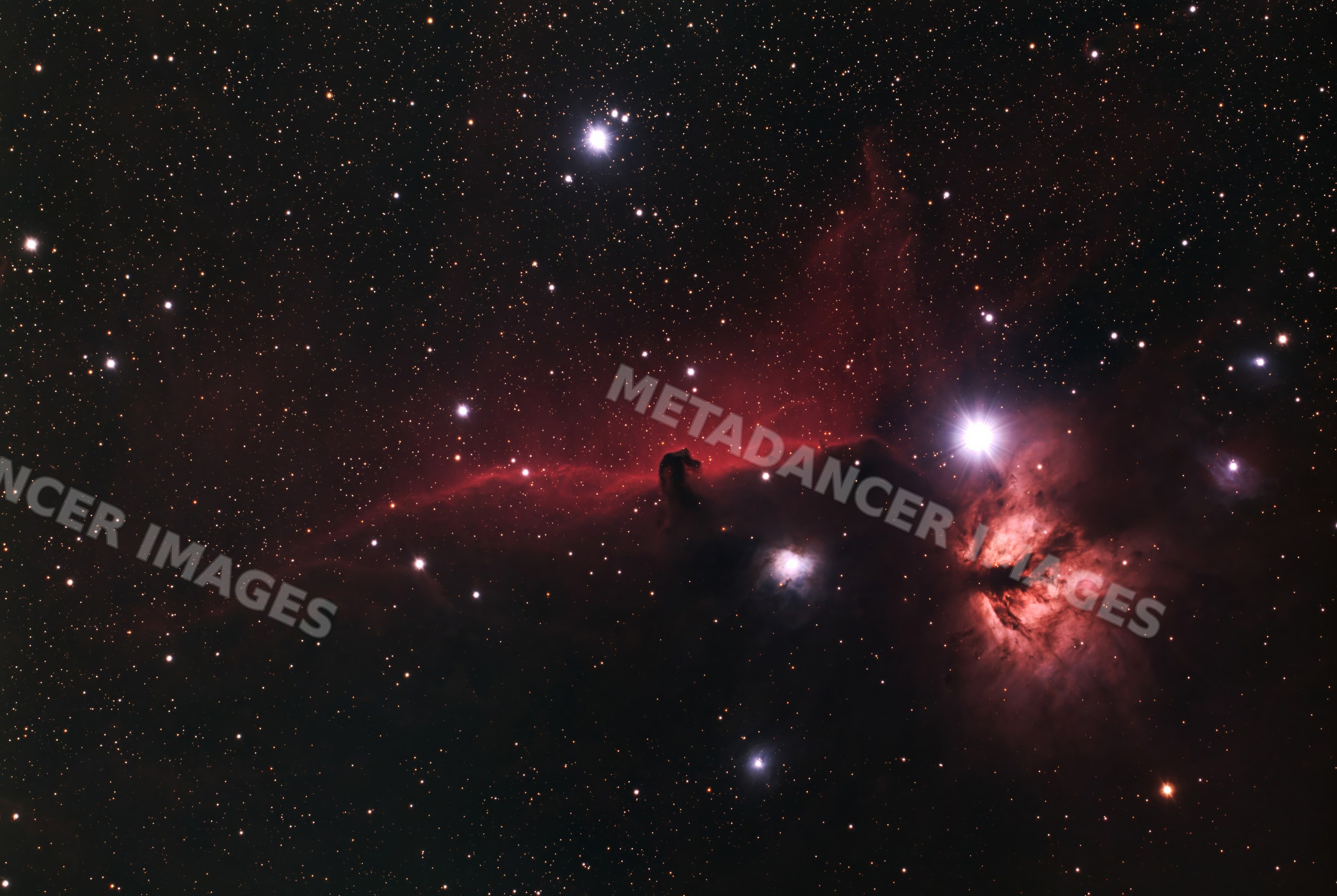 Nebula glowing red with stars in deep space astrophotography