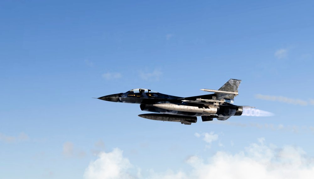 A military fighter jet flying at high speed with afterburners engaged
