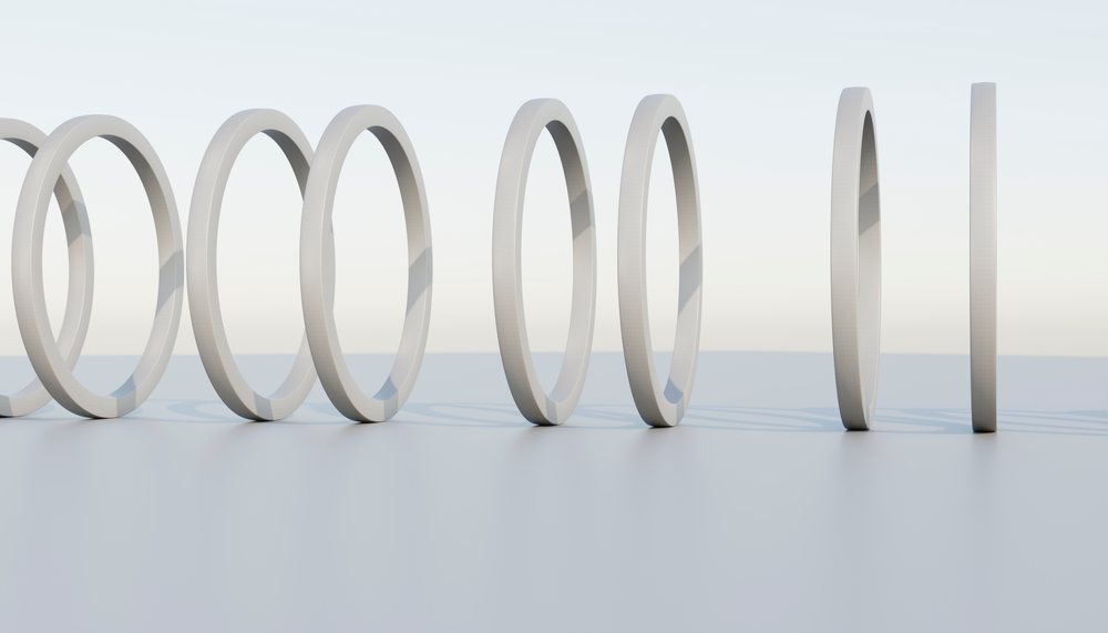 A minimalist sequence of white rings in a clean studio setting