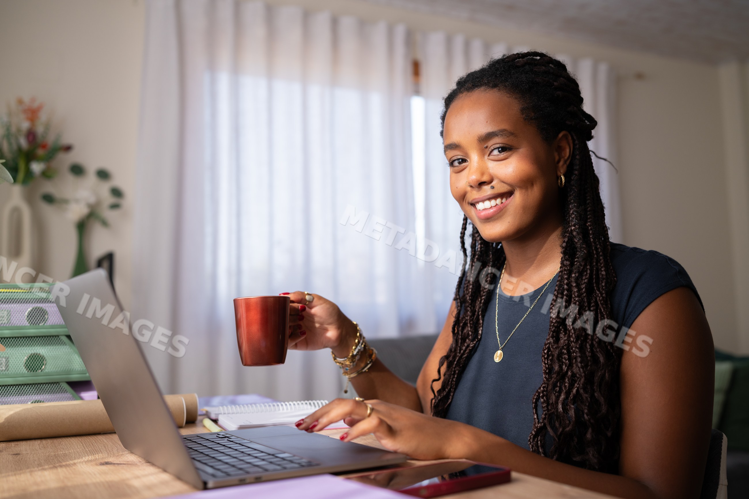 Young African American woman working remotely on a laptop