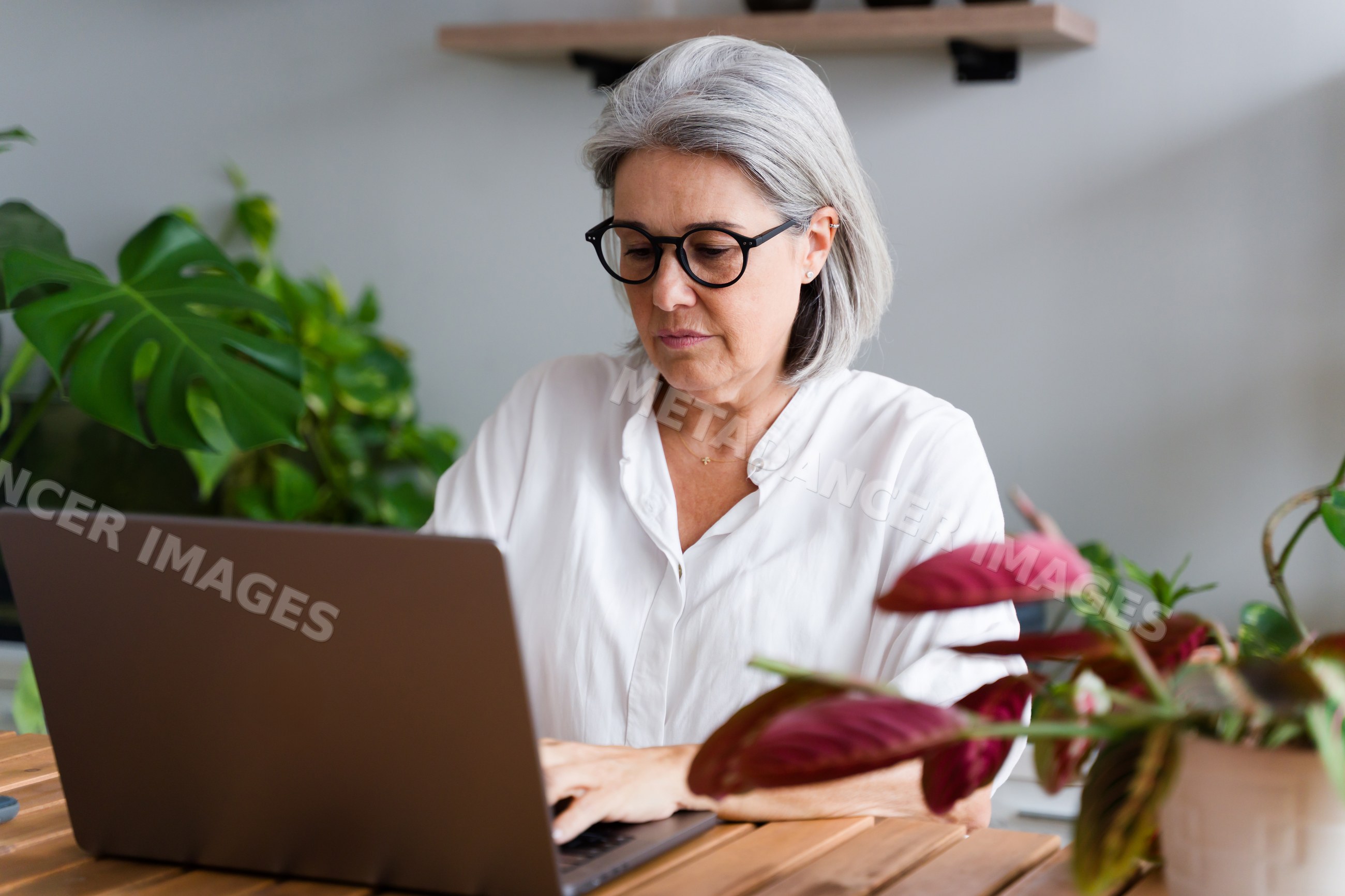 White Woman typing on laptop