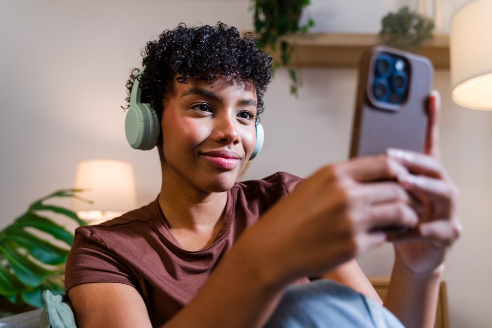 African American woman wearing headphones taking a selfie