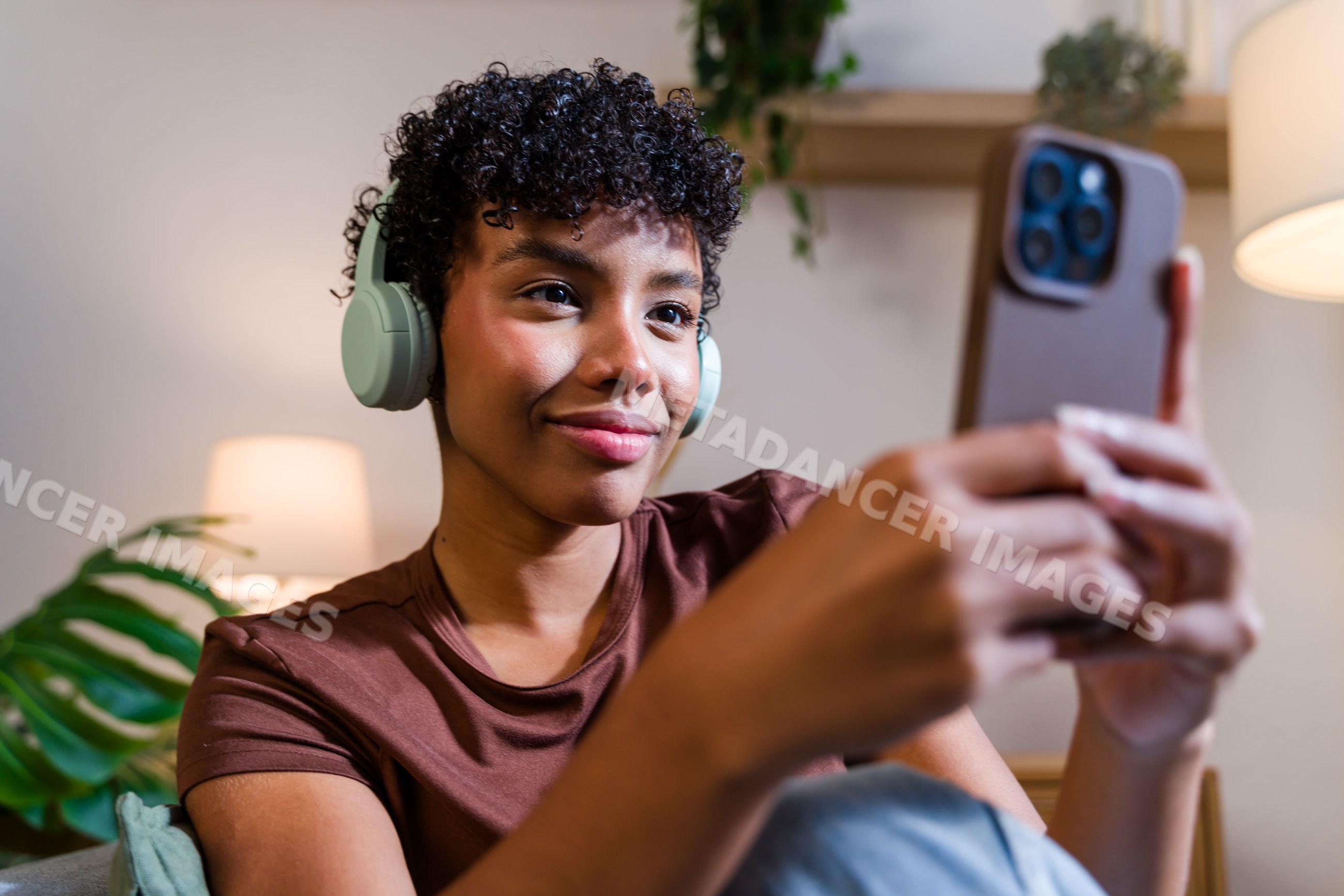African American woman wearing headphones taking a selfie
