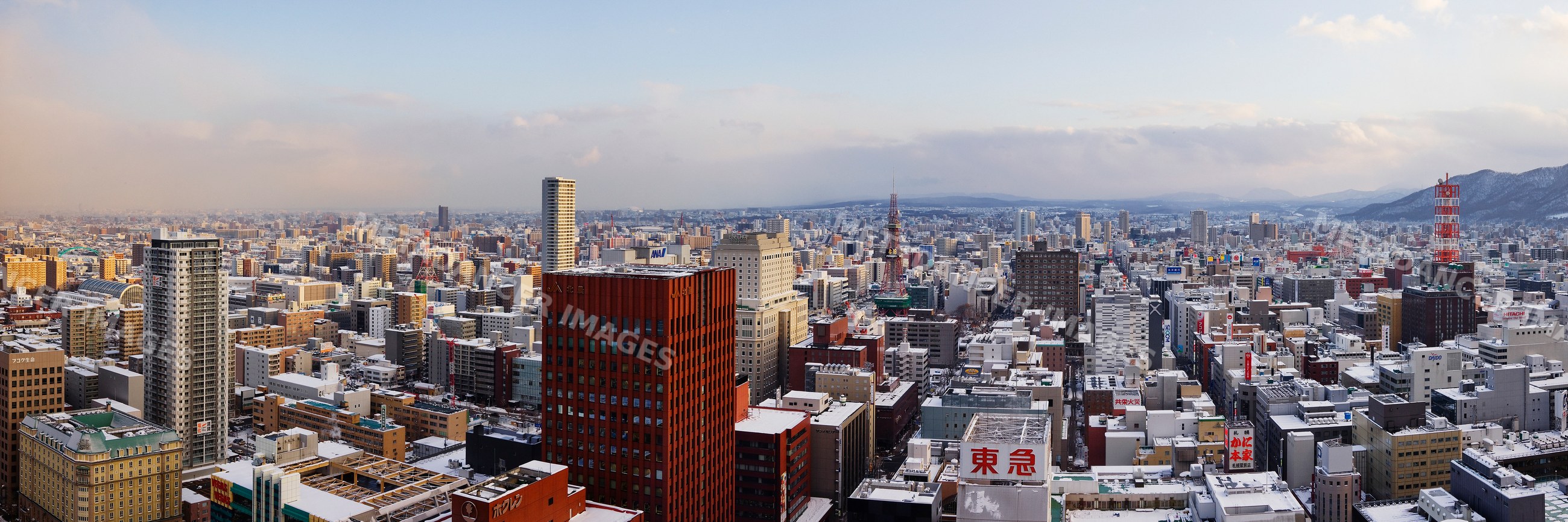 City skyline of sapporo, japan with snow and mountains