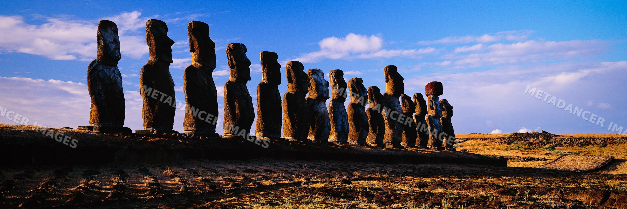 Moai statues on easter island at sunset with dramatic sky