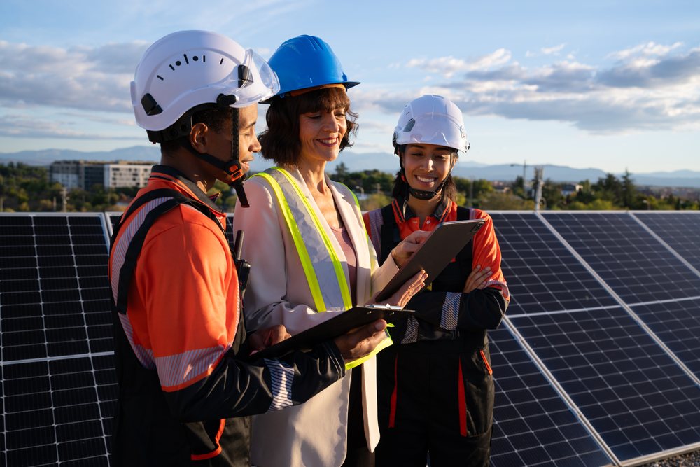 Engineers discussing work near solar panels outdoors in Madrid, Spain