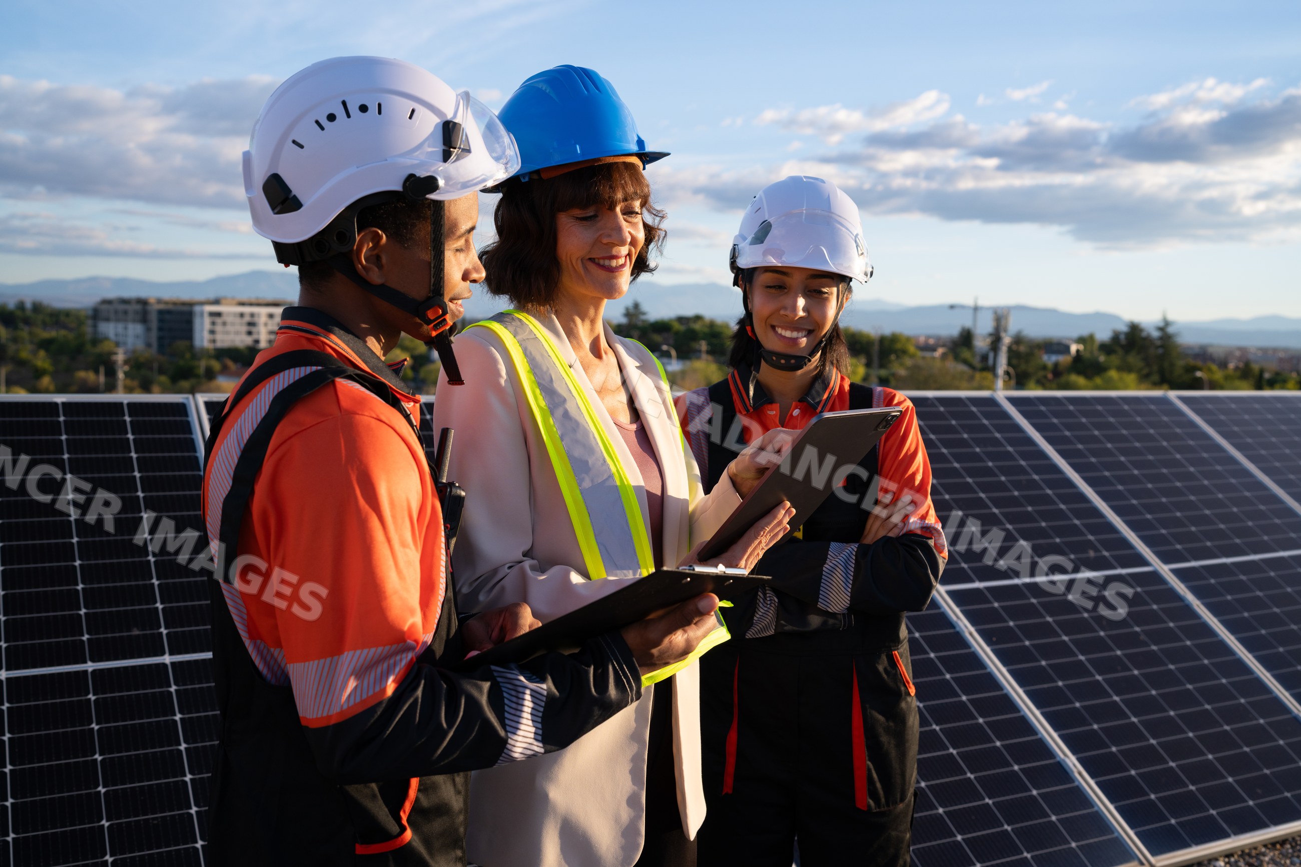 Engineers discussing work near solar panels outdoors in Madrid, Spain