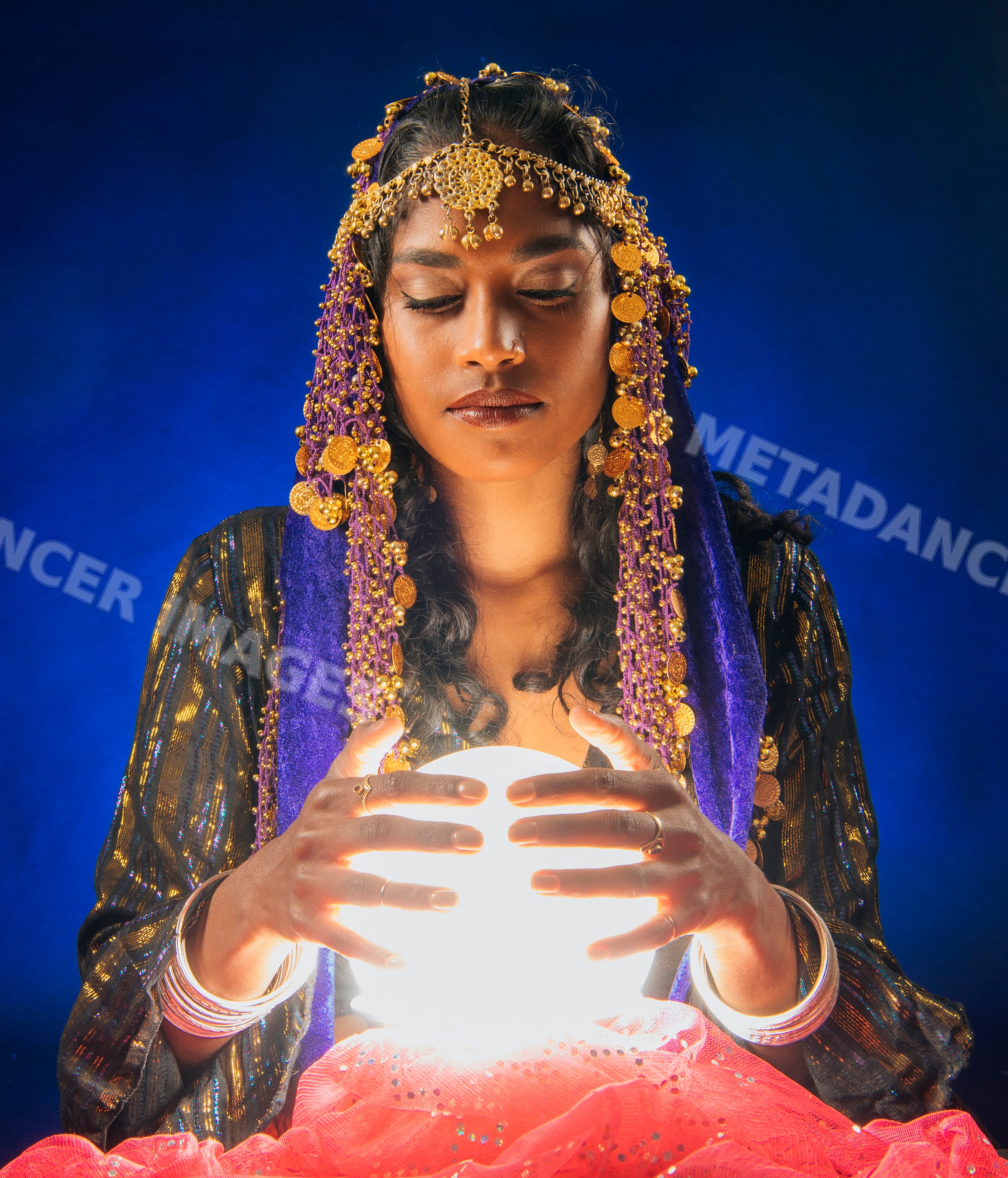 A fortune teller holds a glowing crystal ball with eyes closed
