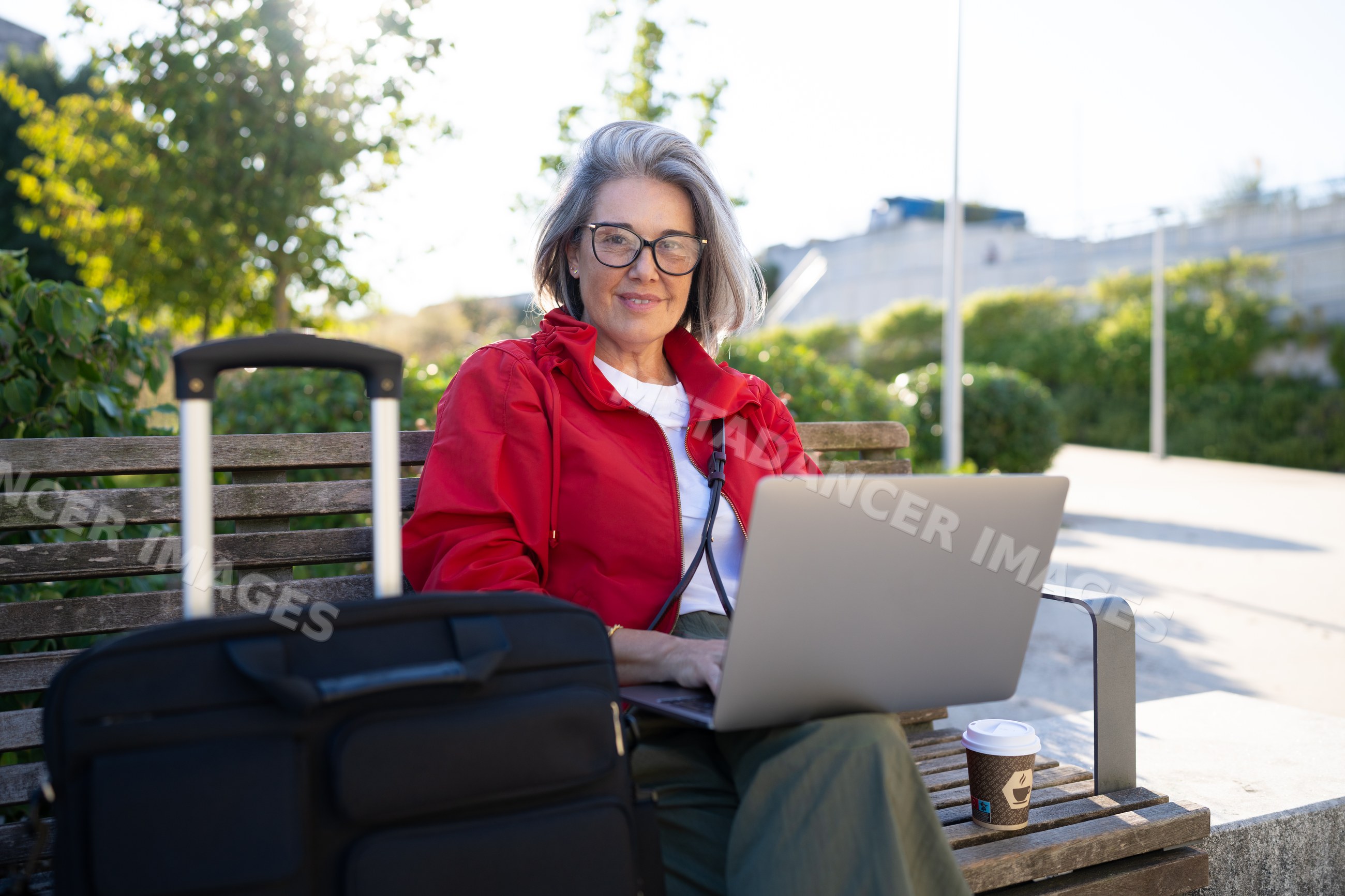 White woman working on laptop outdoors