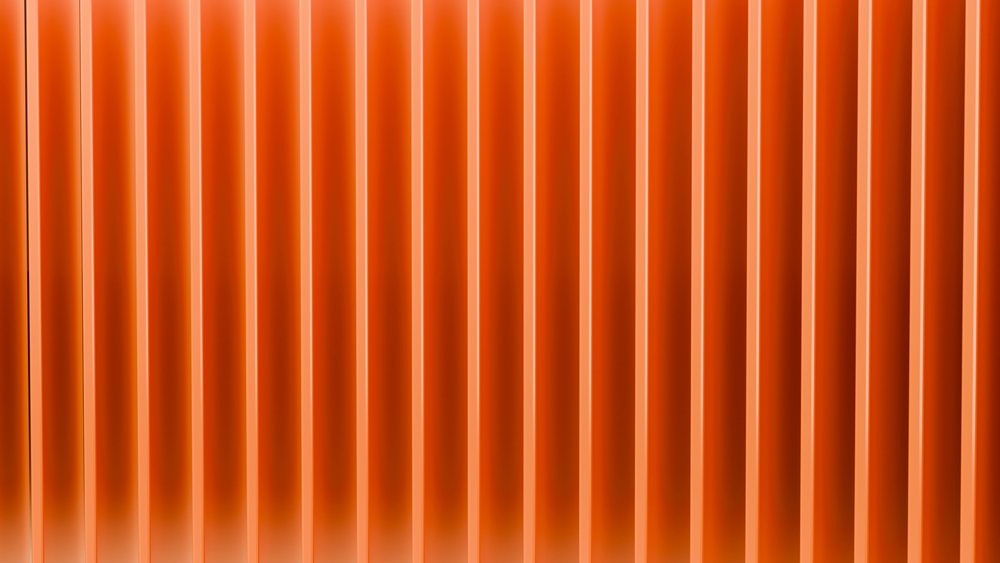 Abstract bright orange vertical striped pattern with smooth vibrant