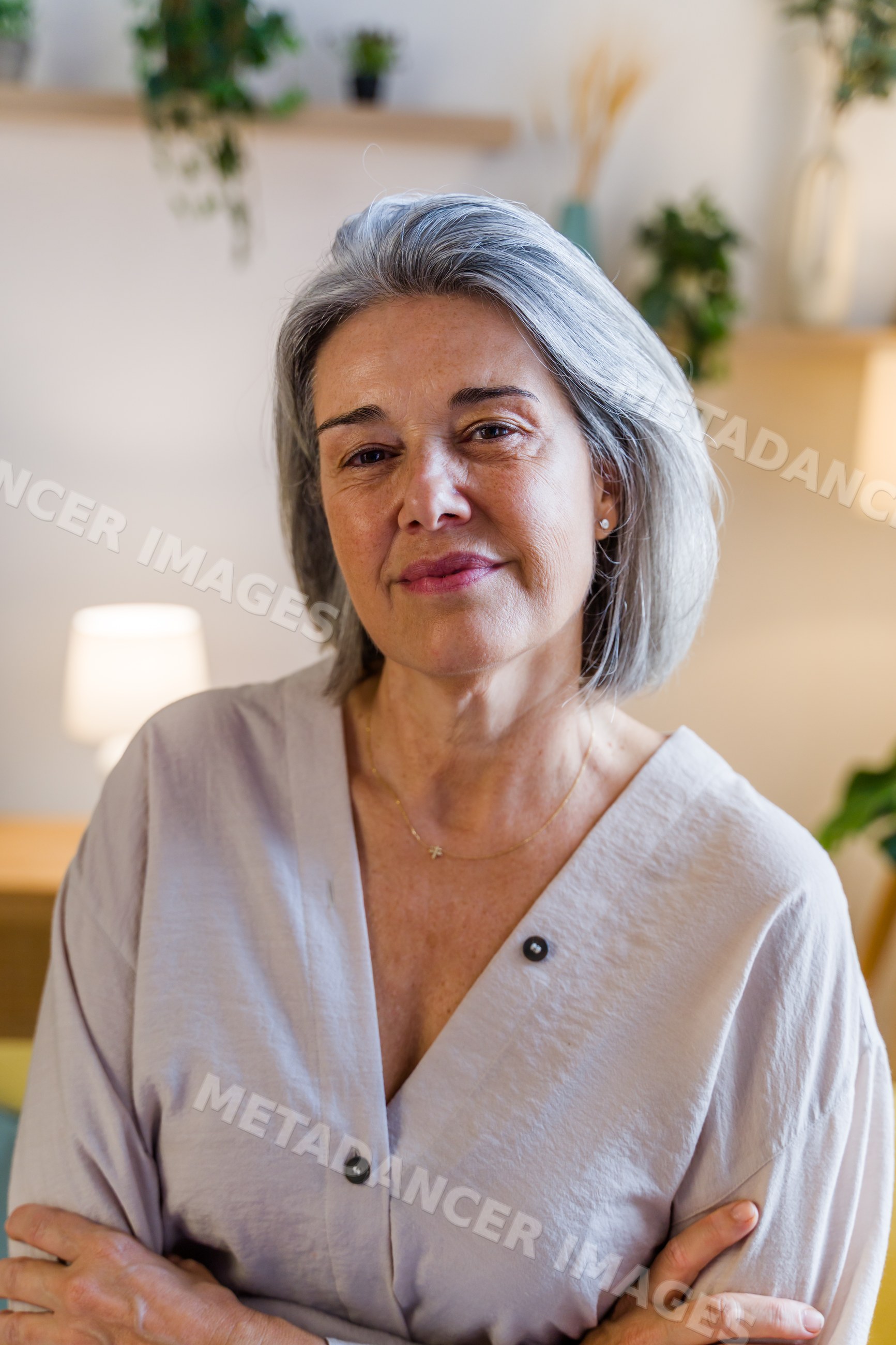 Portrait of mature white woman with gray hair indoors at home