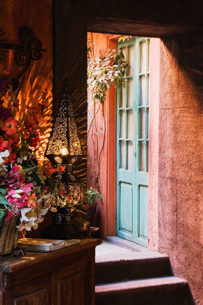 Doorway with blue wooden door and decorative metal lantern, mexico