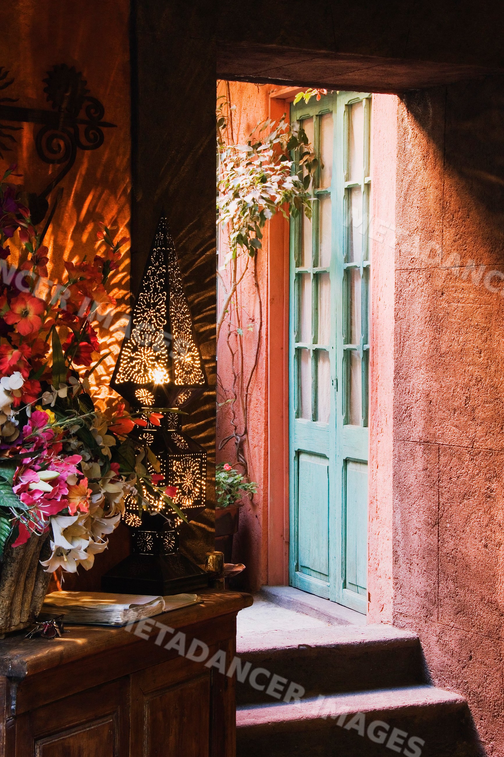 Doorway with blue wooden door and decorative metal lantern, mexico