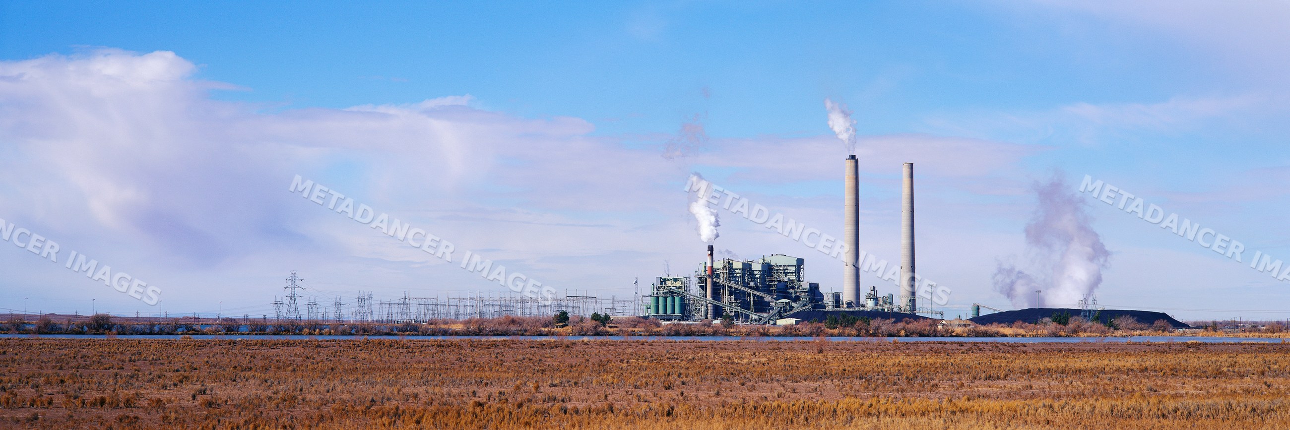 Coal fired power station with smokestacks and electricity pylons, USA