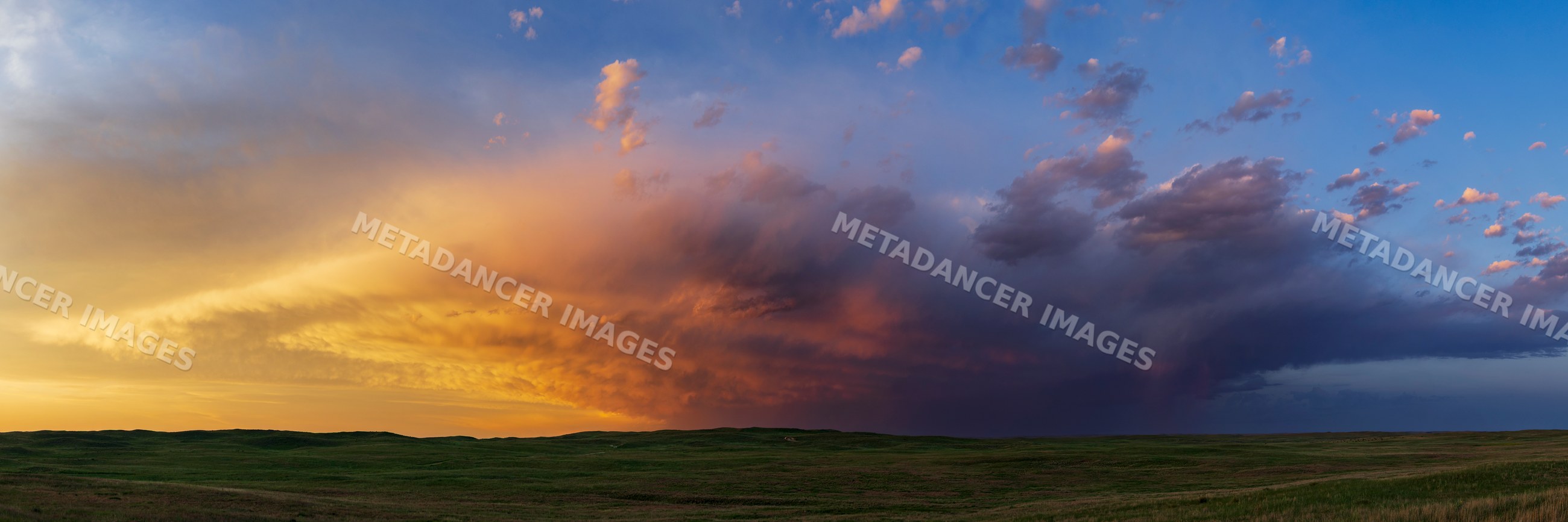 Prairie Sunset with storm clouds over nebraska sandhills landscape