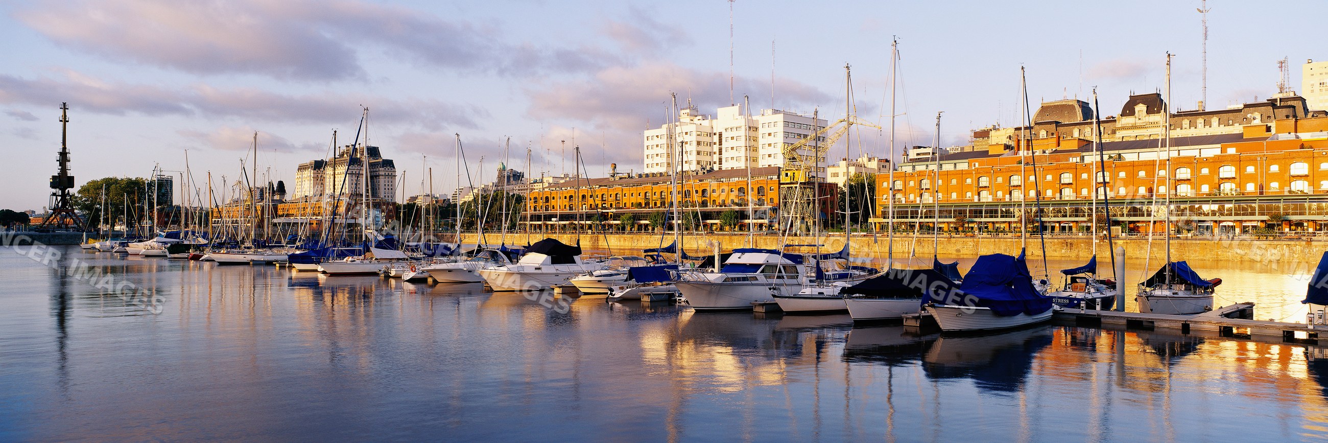 Boats docked at marina along puerto madero waterfront in buenos aires
