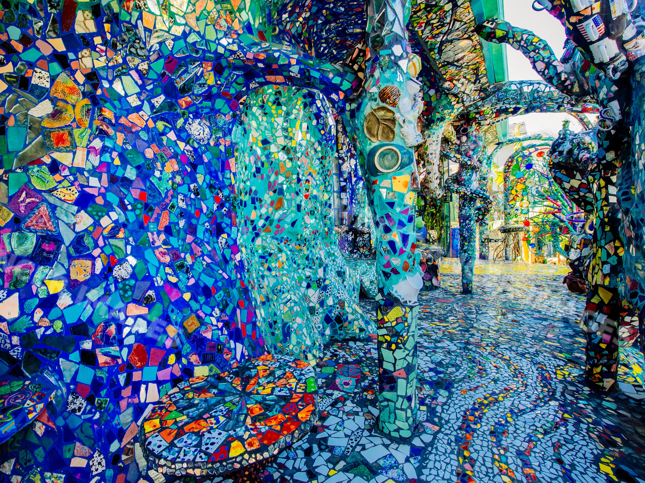 Colorful tile mosaic art installation with decorated walls, columns