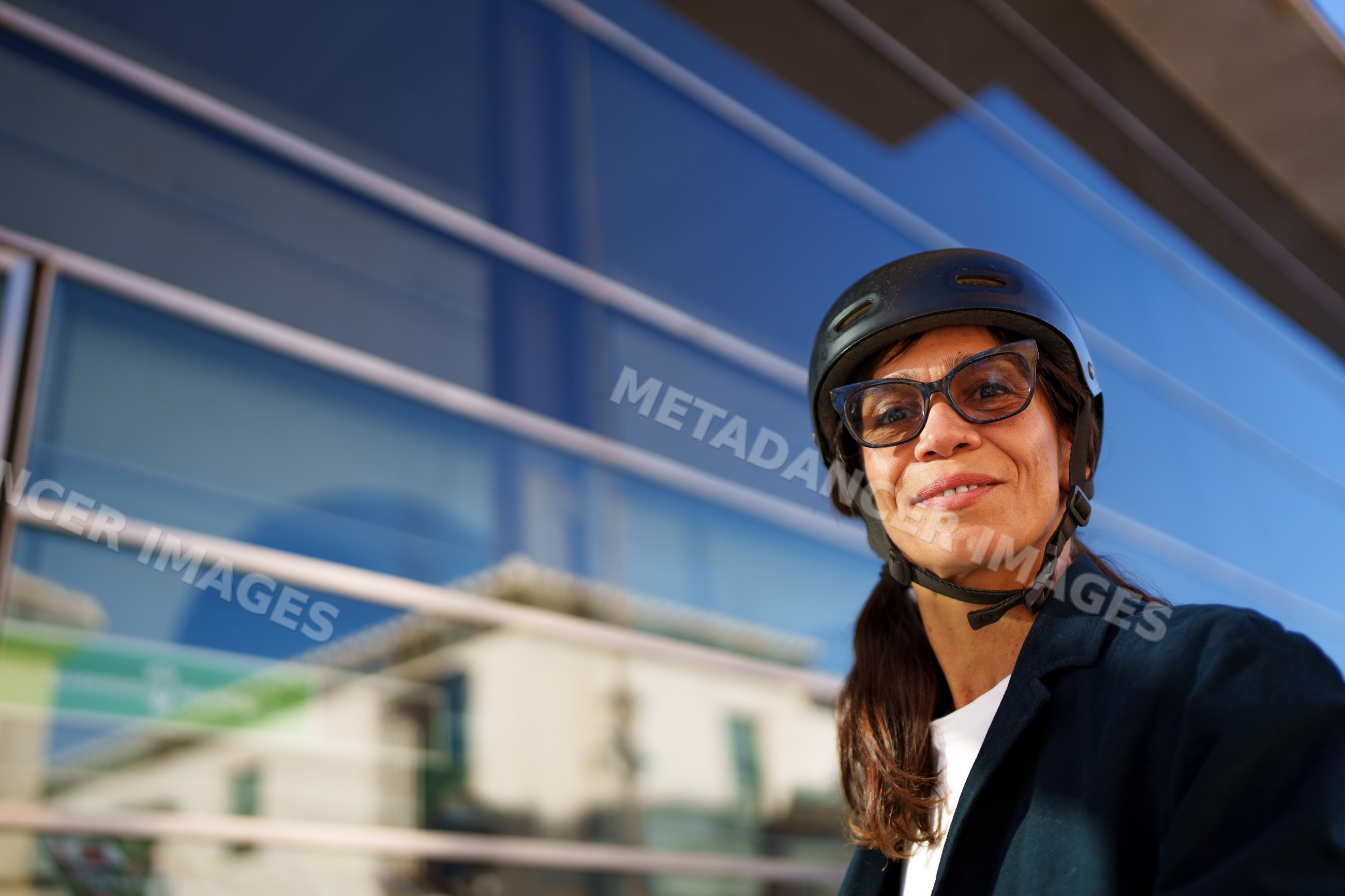 Hispanic woman wearing helmet and glasses outdoors