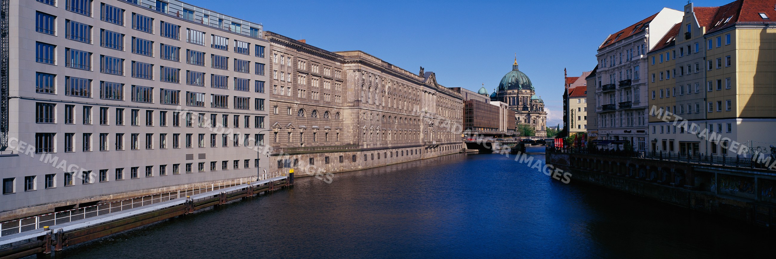 River spree flowing between historic and modern buildings in berlin