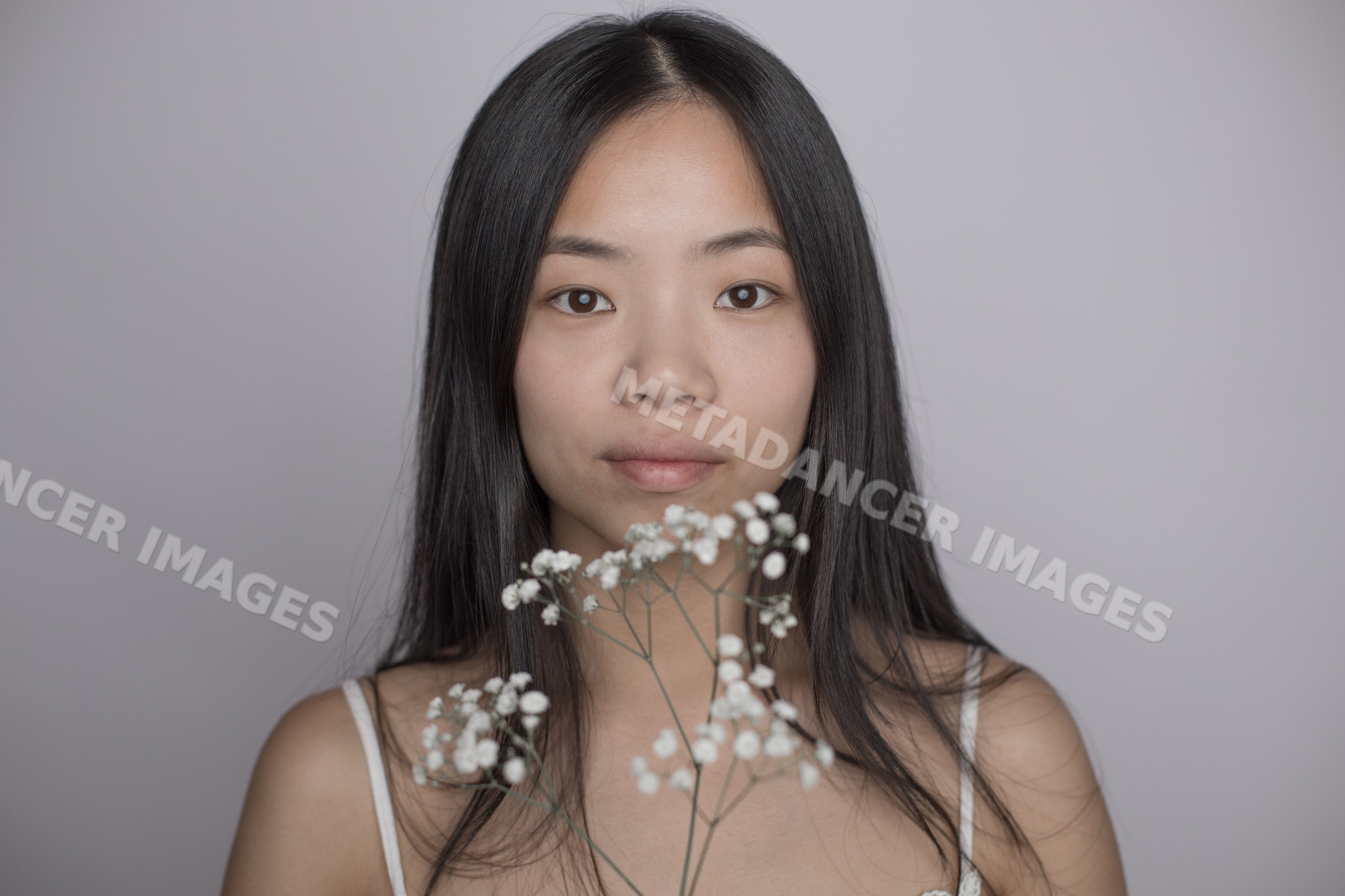 Portrait of an asian Southeast Asian woman holding delicate white
