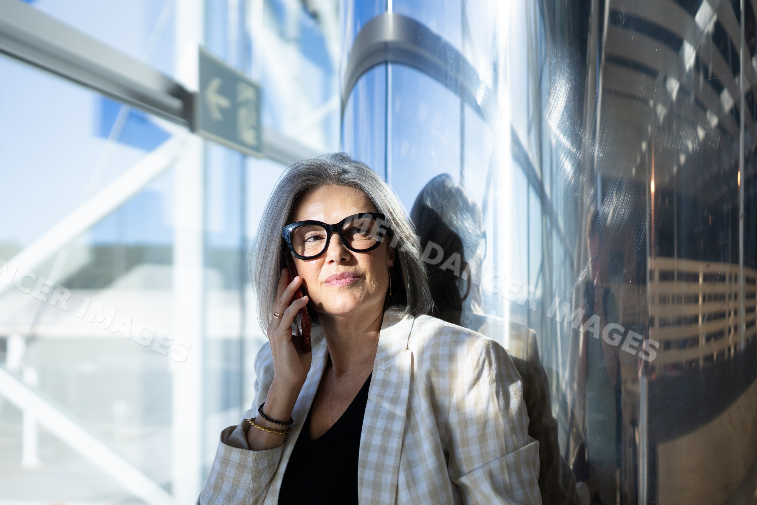 Businesswoman with gray hair making phone call