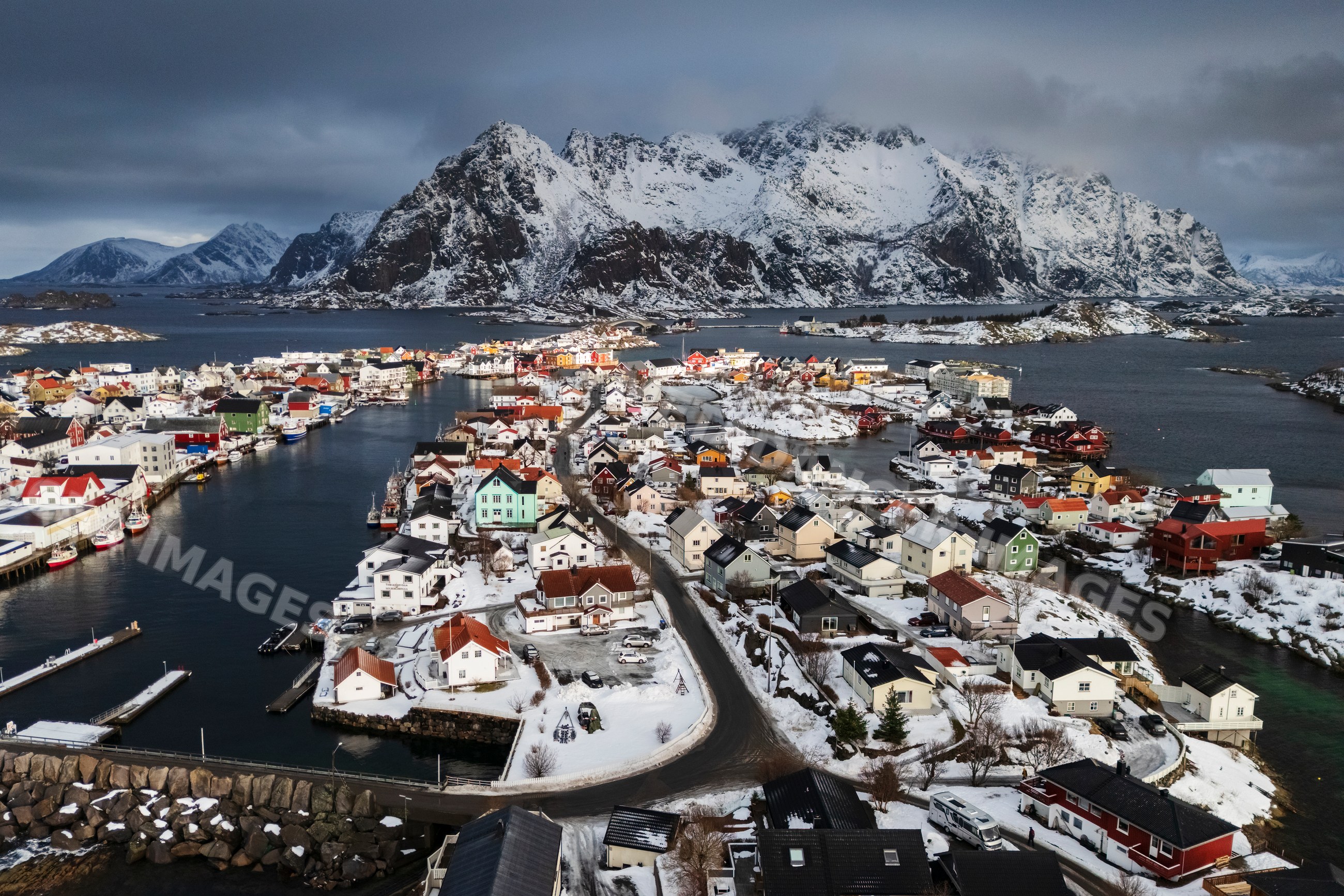 Aerial view of the town of Henningsvaer with snowy mountains