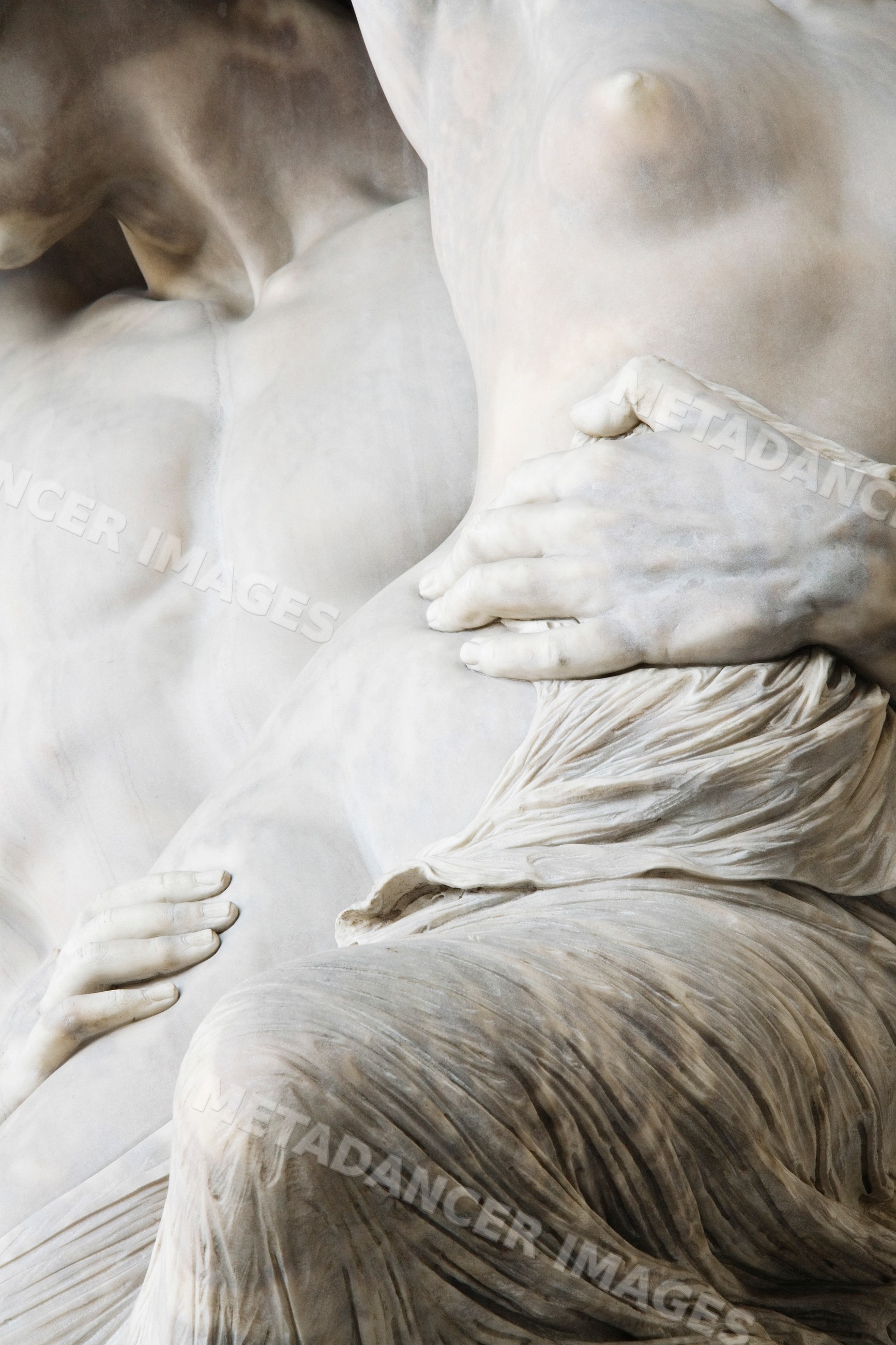 Marble sculpture detail of intertwined human figures italy