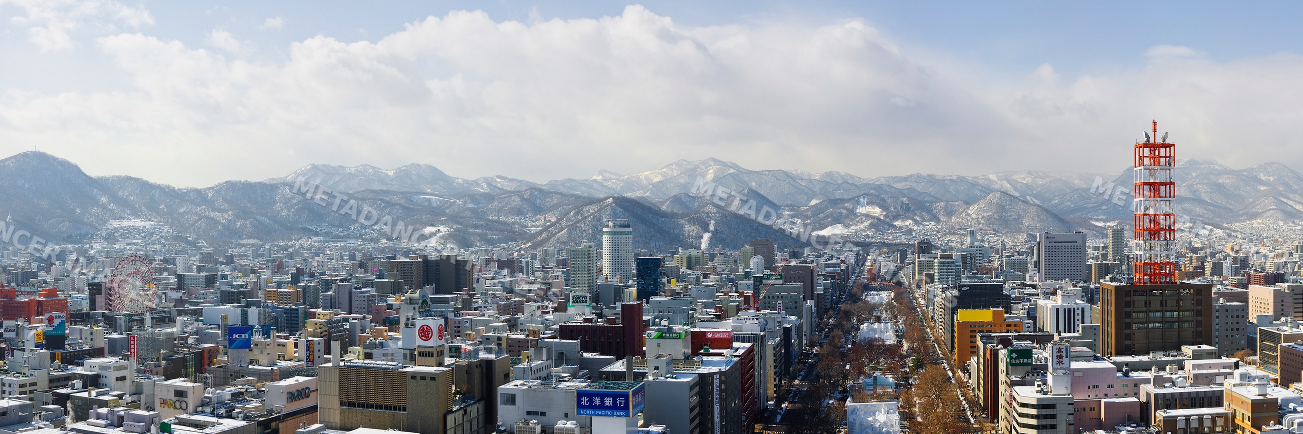 City skyline of sapporo japan with snowy mountains