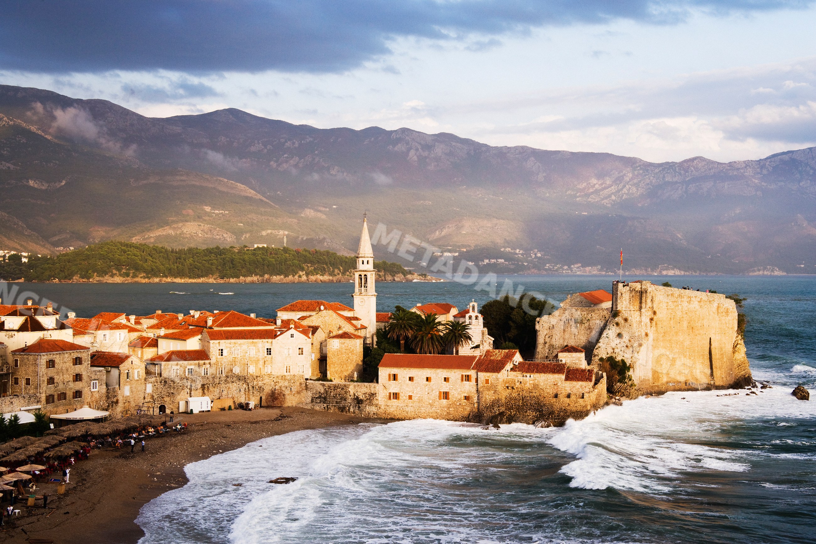 Historic coastal town with fortress and church tower