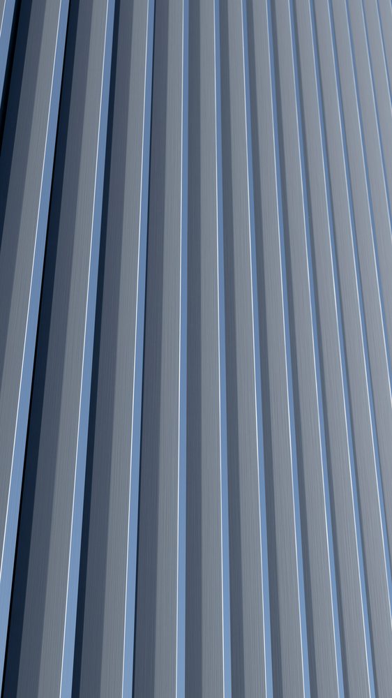 Patterned vertical metal panels on an industrial wall surface