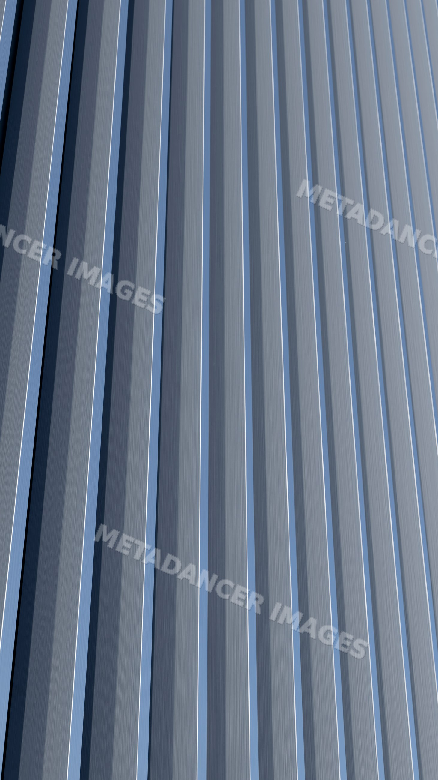 Patterned vertical metal panels on an industrial wall surface